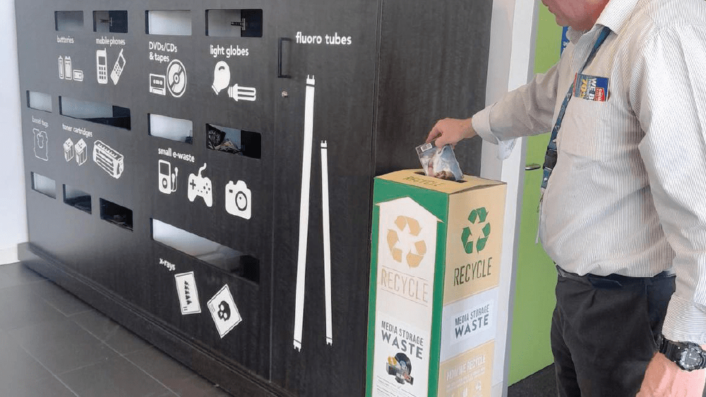 Man putting rubbish into a Zero Waste Box at the Sorell Council recycling hub.